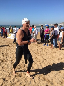 Argan Sports athlete running out of the water on the beach at Agidir Triathlon