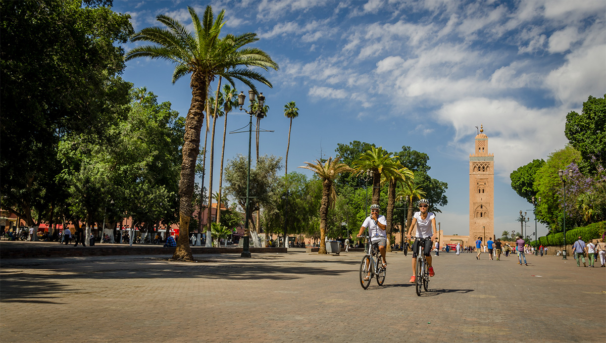 Picture of two Argan Sports customers riding in the main square of Marrakech with the Koutbia mosque in the background